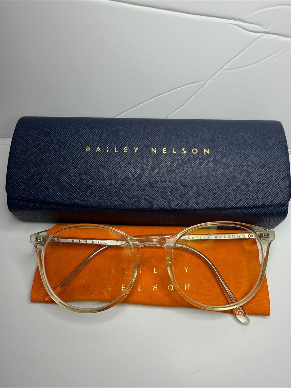 Bailey Nelson Clear Round Glasses with Orange Pouch and Navy Case
